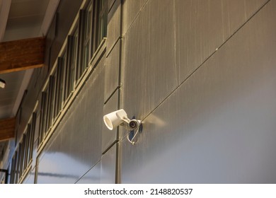 View Of Outdoor Speaker And Public Safety Surveillance Camera On Gray Wall. Sweden.