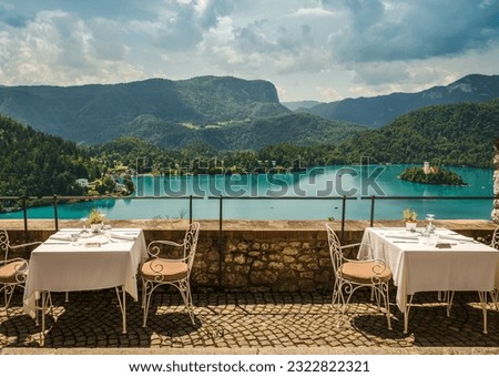View of outdoor terrace of restaurant overlooking Lake Bled, Slovenia; Alps mountains in background