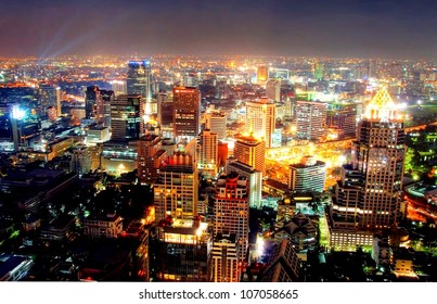a view over the big asian city of Bangkok , Thailand at nighttime when the tall skyscrapers are illuminated - Powered by Shutterstock