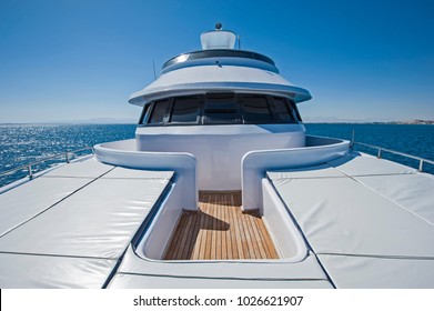 View over the bow of a large luxury motor yacht on tropical open ocean with bridge - Powered by Shutterstock