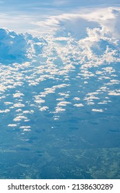 View Over The Clouds Above Tanzania. Bright Skyscape And Green Land Beyond