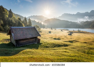 View over Geroldsee with wooden hut and Karwendel mountains at early morning in autumn, Bavaria, Germany - Powered by Shutterstock