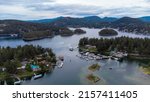 View over Gerrans Bay, Madeira Park Sunshine Coast showing inlet with mountains, forest, mored boats, 