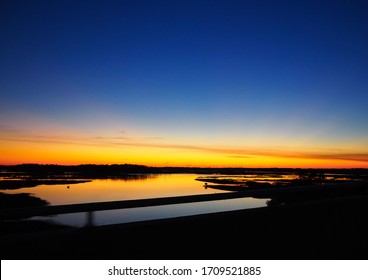 The View Over A Marshy Section Of The Skidaway River Near Savannah, Georgia From A Bridge Just After Sunset On A Winter Evening. 