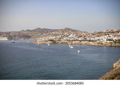 View over Megali Ammos Bay on Mykonos, Greece. Sailboats anchoring during sunset.