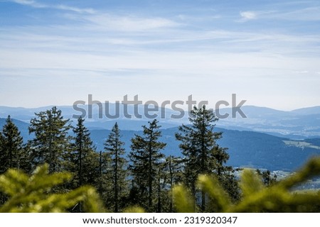 View over the mountains of the Bavarian Forest with trees in the foreground