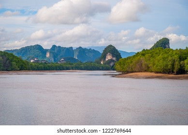 View over muddy Krabi river and scenic landscape of karst mountains, Thailand