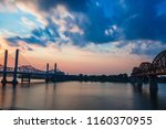 View over the Ohio River in between the Big Four Bridge and the Abraham Lincoln Expressway. Long exposure sky and water movement.