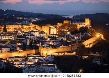 View over the old town and walls of Obidos floodlit at night, Obidos, Centro Region, Estremadura, Portugal, Europe