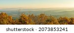 View over Ouachita National Forest from Talimena Scenic byway at sunrise on a November morning, with mist in the valleys and over the hill tops