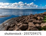 A view over rocks out across the bay on the shoreline at Victoria Park in Charlottetown, Prince Edward Island, Canada in the fall