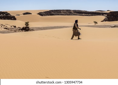 View over a sandy plain with isolated rock formations, Chad.