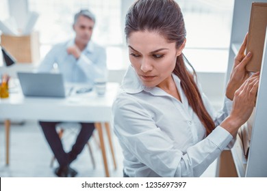 View Over Shoulder. Appealing Good-looking Employee Looking Over Her Shoulder At Her Abusive Boss