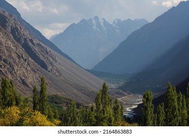 View over the snow covered peak, and mountain ranges, river and valley on the way to  Shandur Pass, Chitral, Khyber Pakhtunkhwa, Pakistan