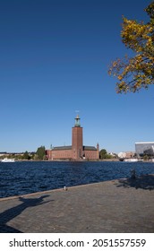 View over the Stockholm City Hall from terrace of troubadour Evert Taube on the island Riddarholmen with a shadow of the troubadour statue