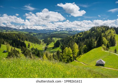 view over Trub with hills and forests of Emmental towards the bernese alps - Shutterstock ID 1998261611