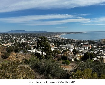 A view overlooking the city of Ventura featuring the Ventura Pier, Mission San Buenaventura, the Pacific Ocean, and the Channel Islands on a beautiful day with wispy clouds. - Shutterstock ID 2254875581