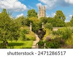 View to Oxford Botanic Garden with Magdalen Tower at distance. Oxford, England