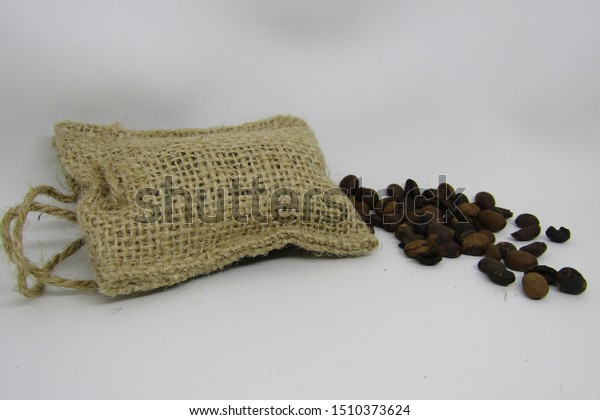 View of parfum kopi bali or Car air freshener
and room perfume with authentic Bali coffee beans. Fragrance
hanging rope. Packaging small jute sack cubes karung goni. Isolated
on white background