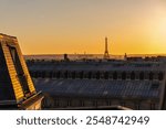 View of Paris and Eiffel Tower and rooftops from above. Beautiful sunset over Paris, France. High quality photo