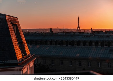 View of Paris and Eiffel Tower and rooftops from above. Beautiful sunset over Paris, France. High quality photo