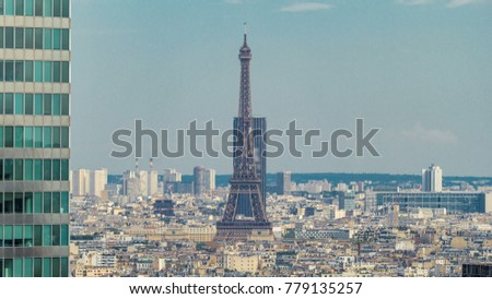 View of Paris and Eiffel Tower timelapse from the top of the skyscrapers in Paris business district La Defense. Sunny summer day. Paris, France