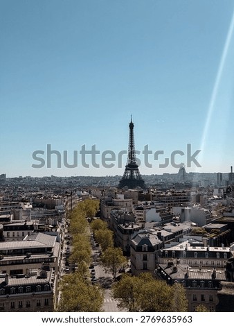View of Paris skyline including Eiffel Tower from Arc de Triomphe under blue sky