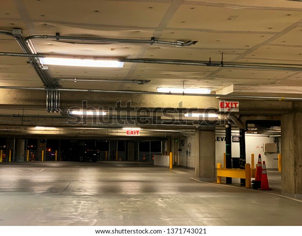 A view of a parking\
garage at night