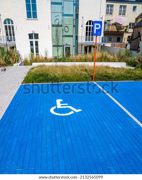 A view of parking space for disabled persons\
against buildings
