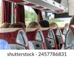 View of the passengers inside a stage coach bus. Bus interior trip. Transport, tourism, road trip and people concept.