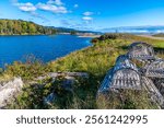 A view past lobster pots along the MacDonalds pond at the Little River on the Cabot Trail, Nova Scotia, Canada in the fall