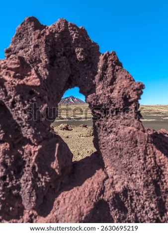 View of the Payun Matru Volcano from a window in the rock