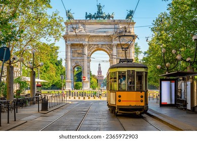 View of the Peace Arch with yellow tram in Milan, Italy