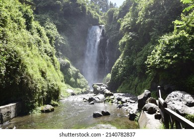 View of Peguche Waterfall in the mountains of Ecuador. It's surrounded by green forest full of vegetation