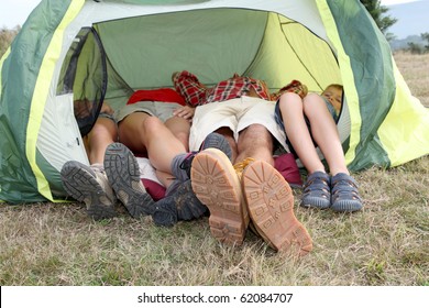 View of people feet from outside a camp tent