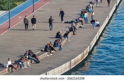 View of people at Karakoy  coastline, seashore Beyoglu district, enjoying sunny day, cityscape,  ( Karaköy,  Galata sahil, ) Istanbul Turkey October 21, 2021