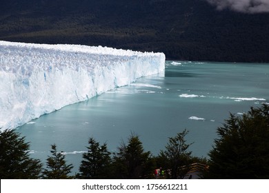 View of Perito Moreno glacier in Argentina with ice melting and floating in the water. Climate change and environmental emergency context. Travel context