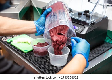 A View Of A Person Preparing An Acai Bowl, In A Restaurant Kitchen Setting.