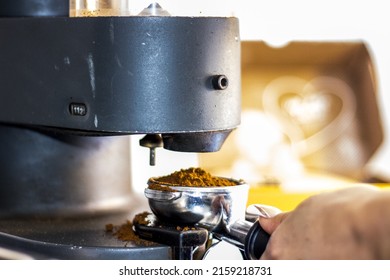 A View Of A Persons Hand Making Coffe In A Coffee Machine