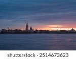 View of the Peter and Paul Fortress and the Neva River against a pink dawn sky with clouds on a sunny spring morning, St. Petersburg, Russia