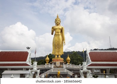 View of Phra Buddha Mongkol Maharat  the Standing Buddha in Hatyai Songkhla with the Words "Phra Buddha Mongkol Maharat" The Name of Buddha under the Statue
