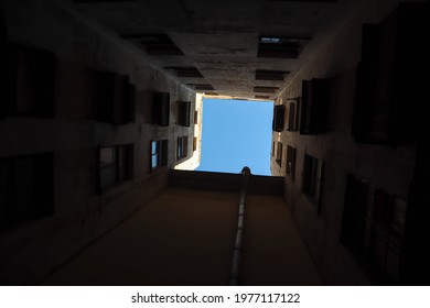 View To The Piece Of Blue Sky From The Bottom Of The Dark Well Yard In Saint Petersburg, Russia