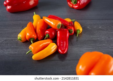 A view of a pile of red, orange, and yellow sweet peppers. - Powered by Shutterstock