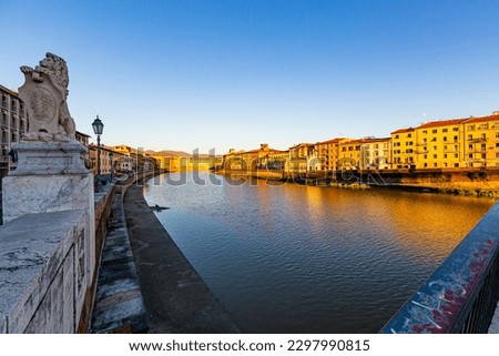 View of Pisa along River Arno with the characteristic gothic church of Santa Maria della Spina at sunset-Tuscany-Italy