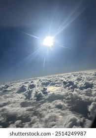 View from plane over ocean with clouds and water sun setting and night fall over the city 