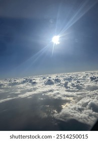 View from plane over ocean with clouds and water sun setting and night fall over the city 