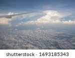 View from a plane window above clouds of Kuala Lumpur, Malaysia in the morning after sky sunset
