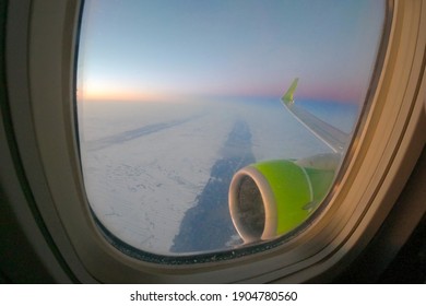 View From The Plane Window Of The Engine And The Snow-covered Siberian Plain. Altai Krai, Siberia, Russia.