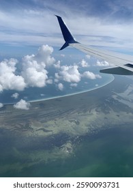 View From Plane Window While Flying Over the Ocean