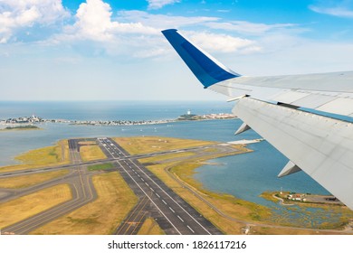 View Of A Plane Wing With Runway Tarmac And Water In The Background